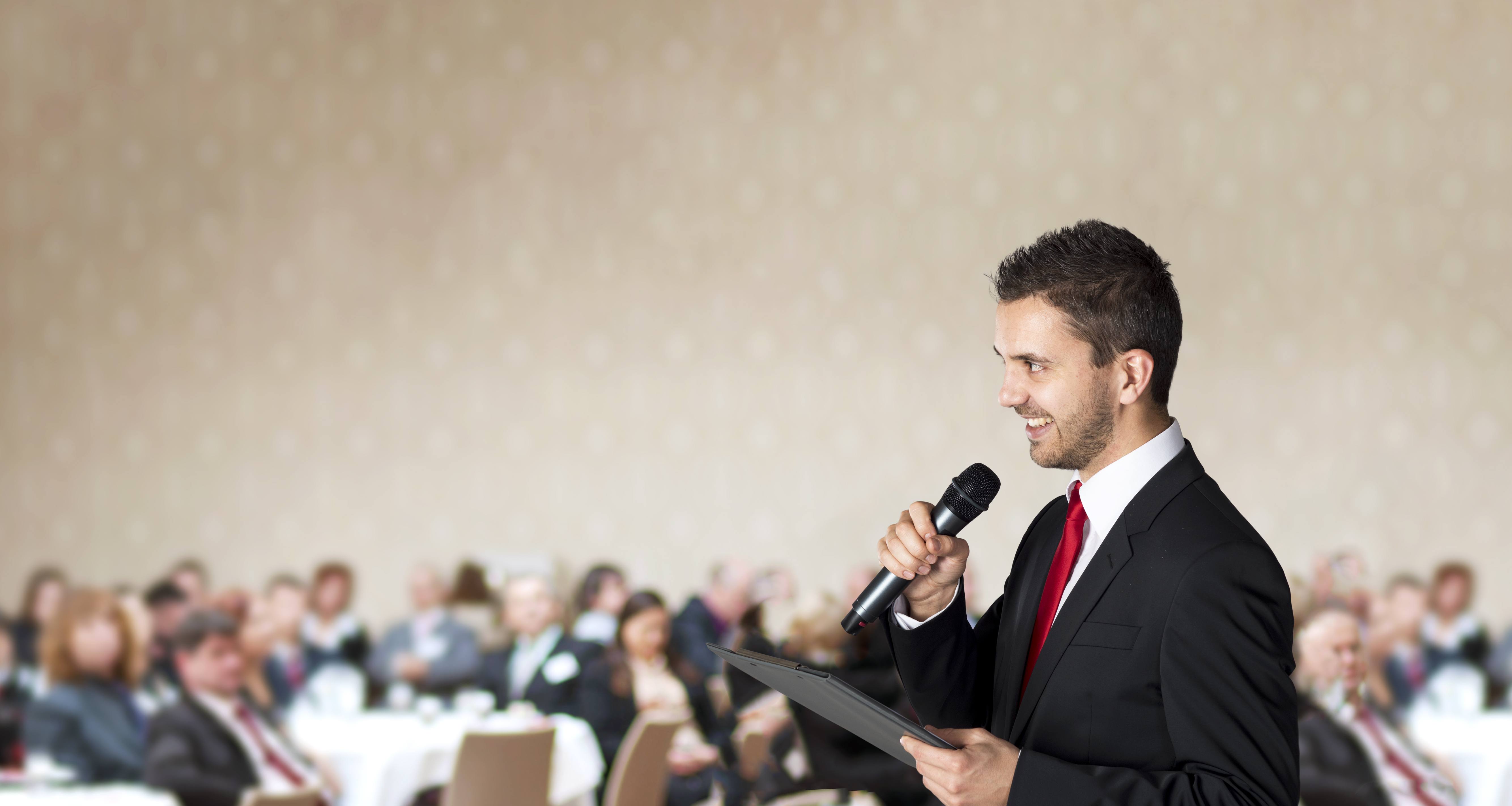 Man is speaking on indoor business conference for managers.