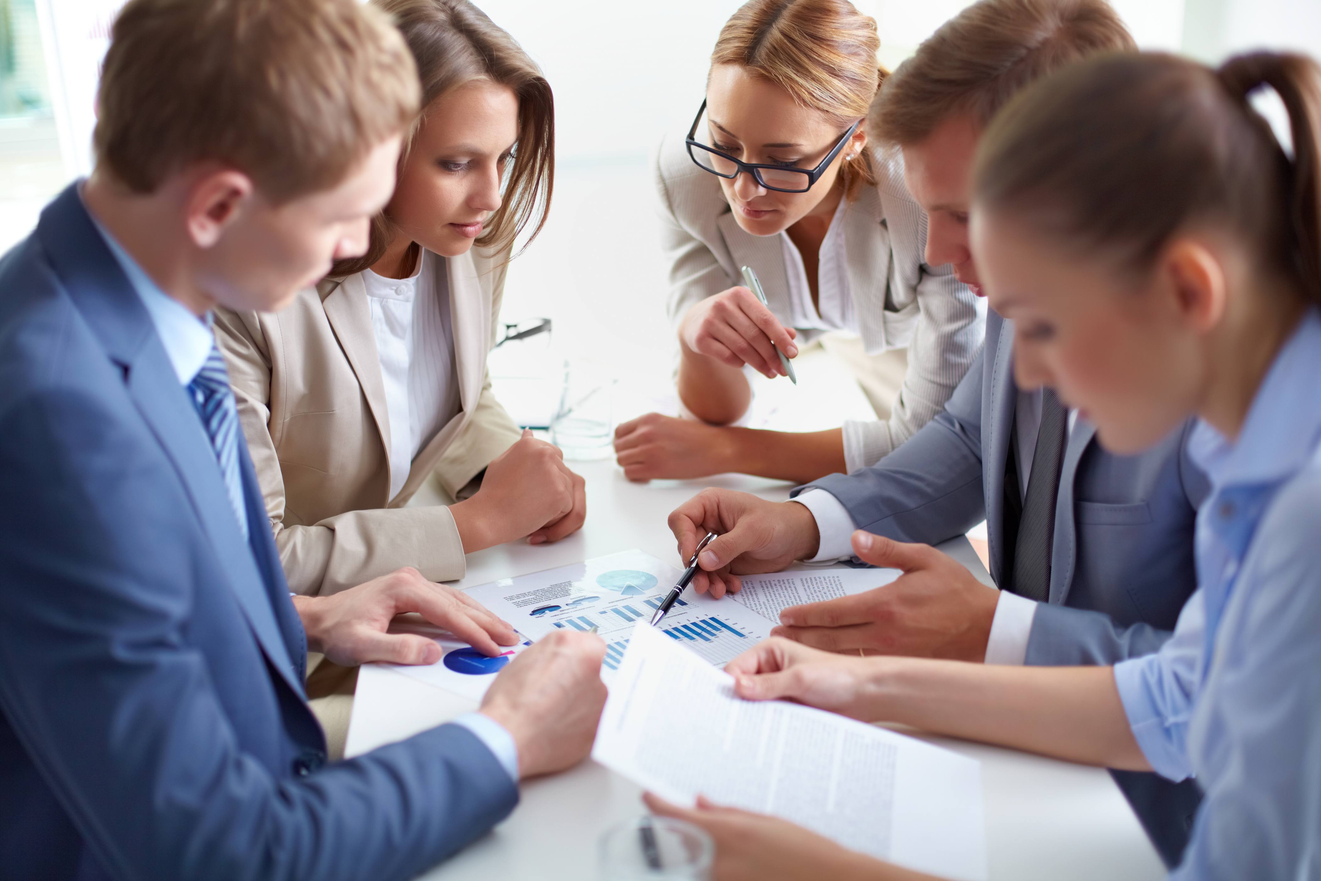 Image of business partners discussing documents at meeting