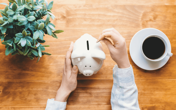 revenue attribution; person putting money into a piggy bank