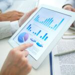 Business document in touchpad held by female during explanation