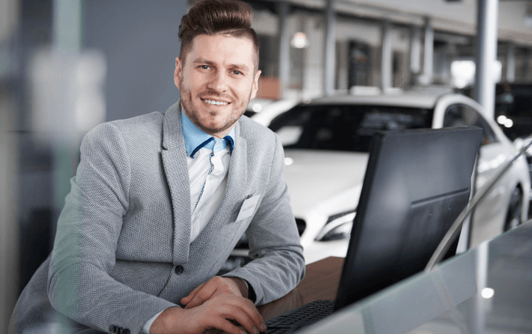 Man in a suit sitting at a desk with a computer