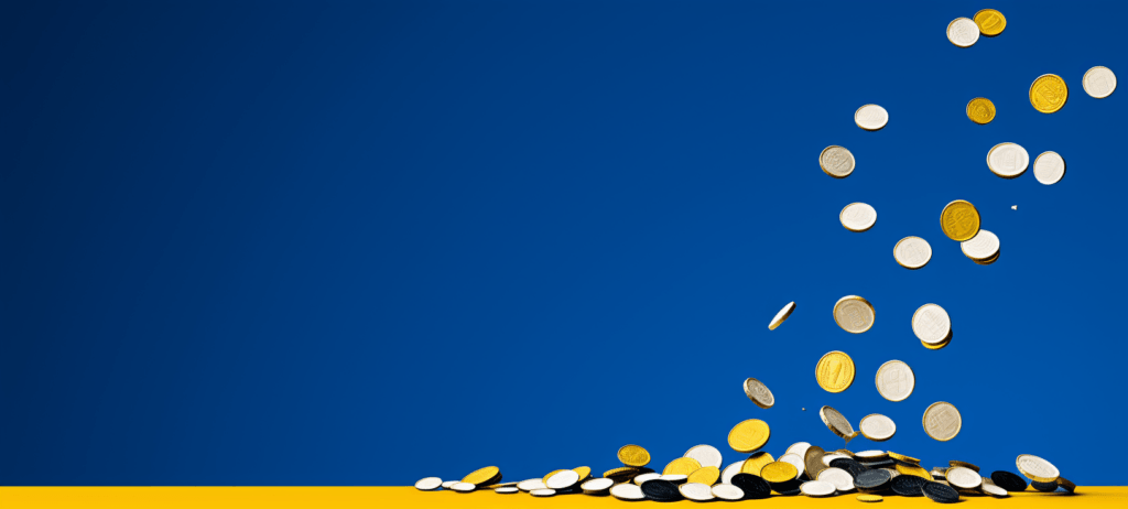 Numerous coins of various sizes and colors are scattered in mid-air against a blue background with a yellow stripe at the bottom, suggesting motion as if the coins have been tossed or are falling.