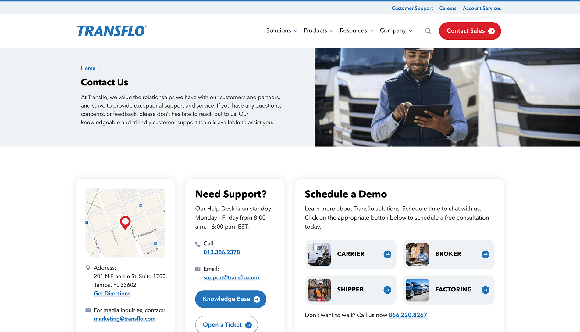 Screenshot of Transflo's 'Contact Us' webpage with navigation menu, a man using a tablet in front of a truck, and sections for address, support contact information, and scheduling a demo.