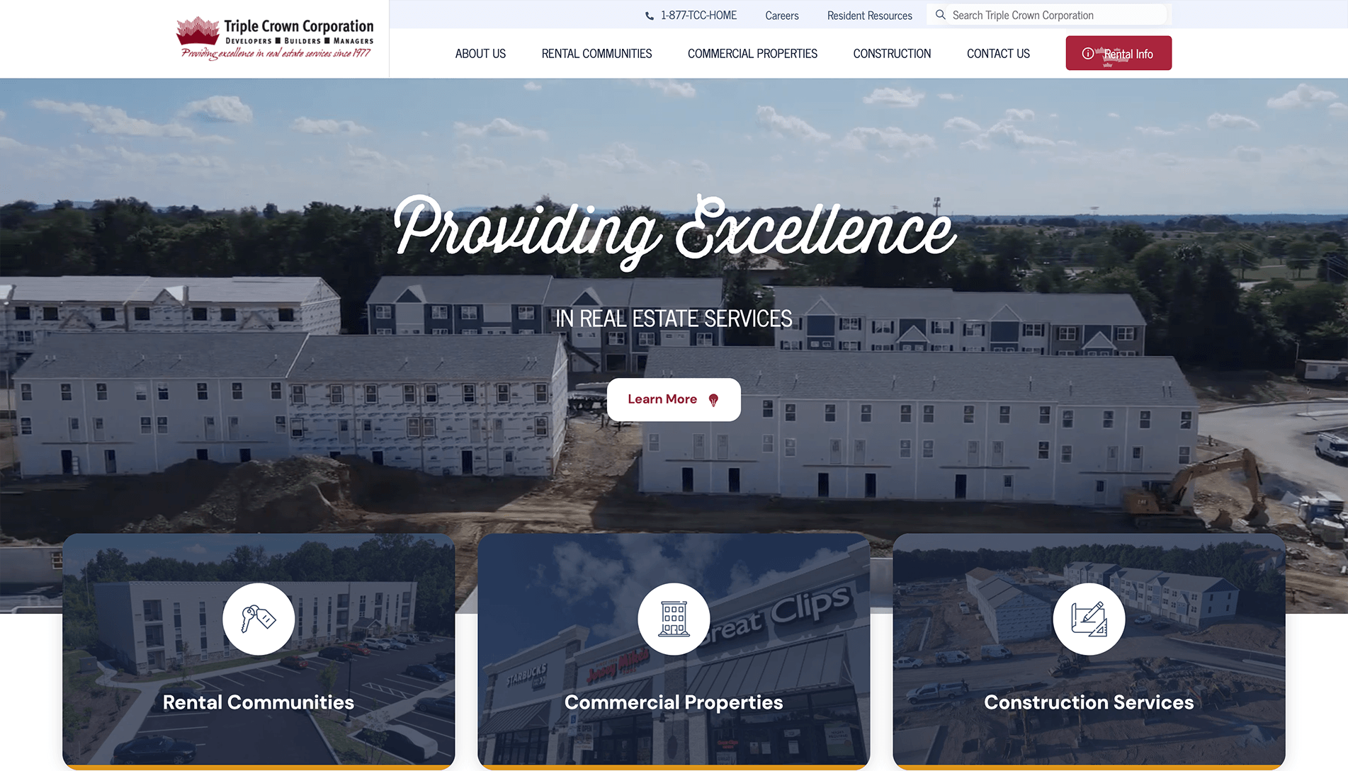 Homepage of Triple Crown Corporation featuring an aerial view of a residential construction site with the tagline 'Providing Excellence in Real Estate Services' and navigation options for Rental Communities, Commercial Properties, and Construction Services.