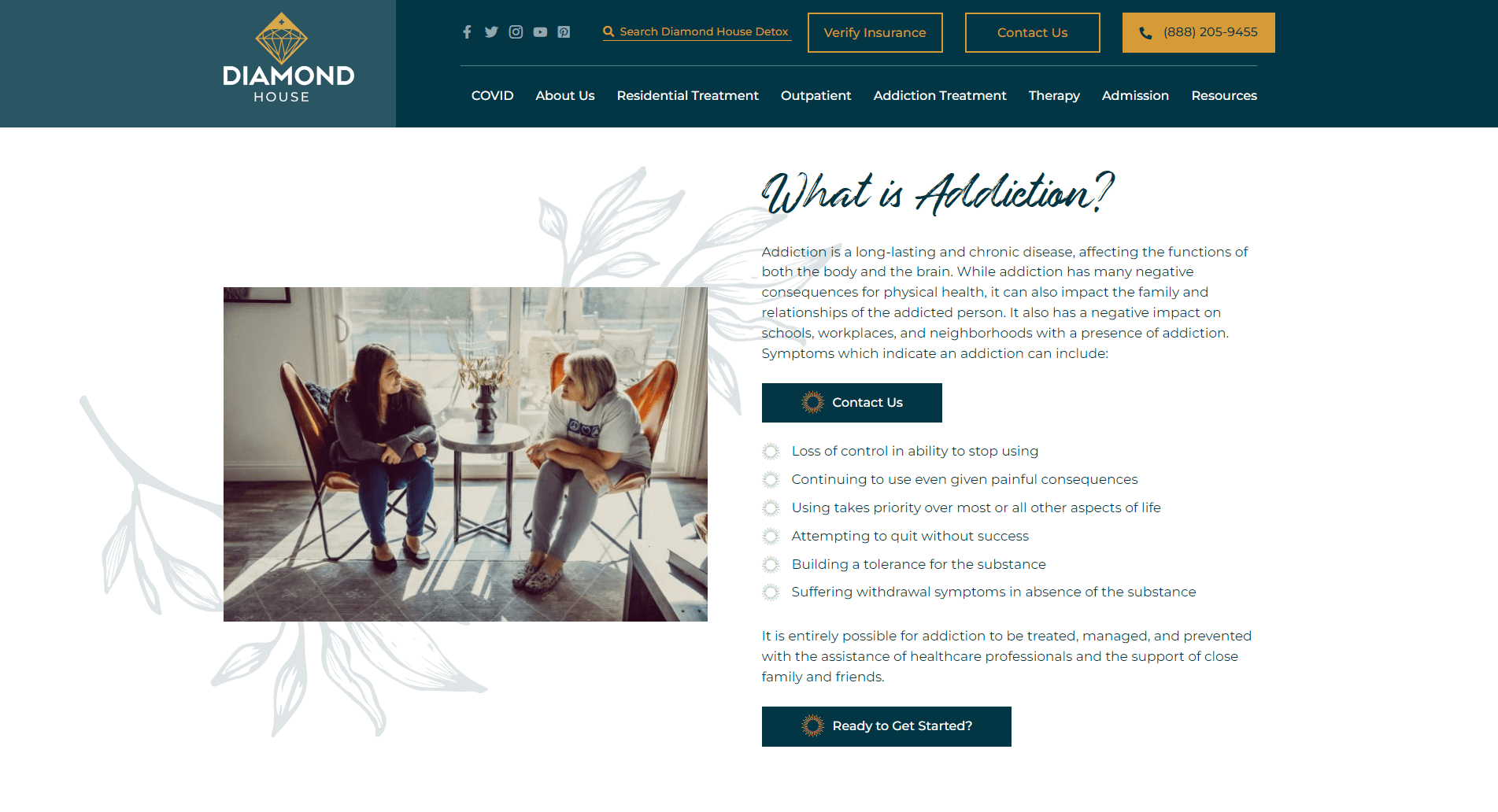 Two women having a conversation in a cozy room with modern furniture, as part of the Diamond House Detox website interface discussing addiction treatment.