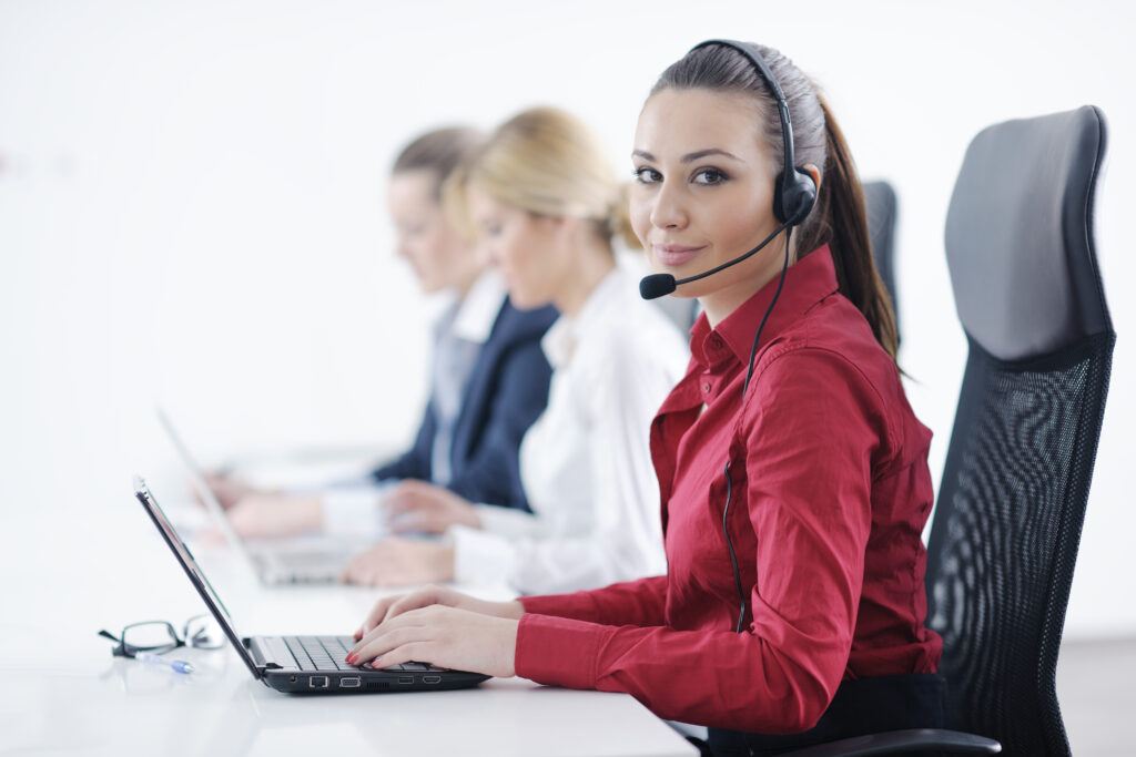 young business woman group with headphones smiling at you against white background