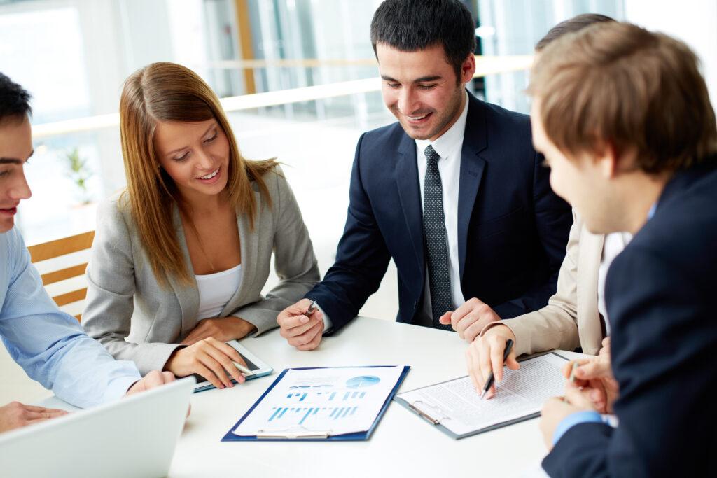 Image of business partners discussing documents at meeting