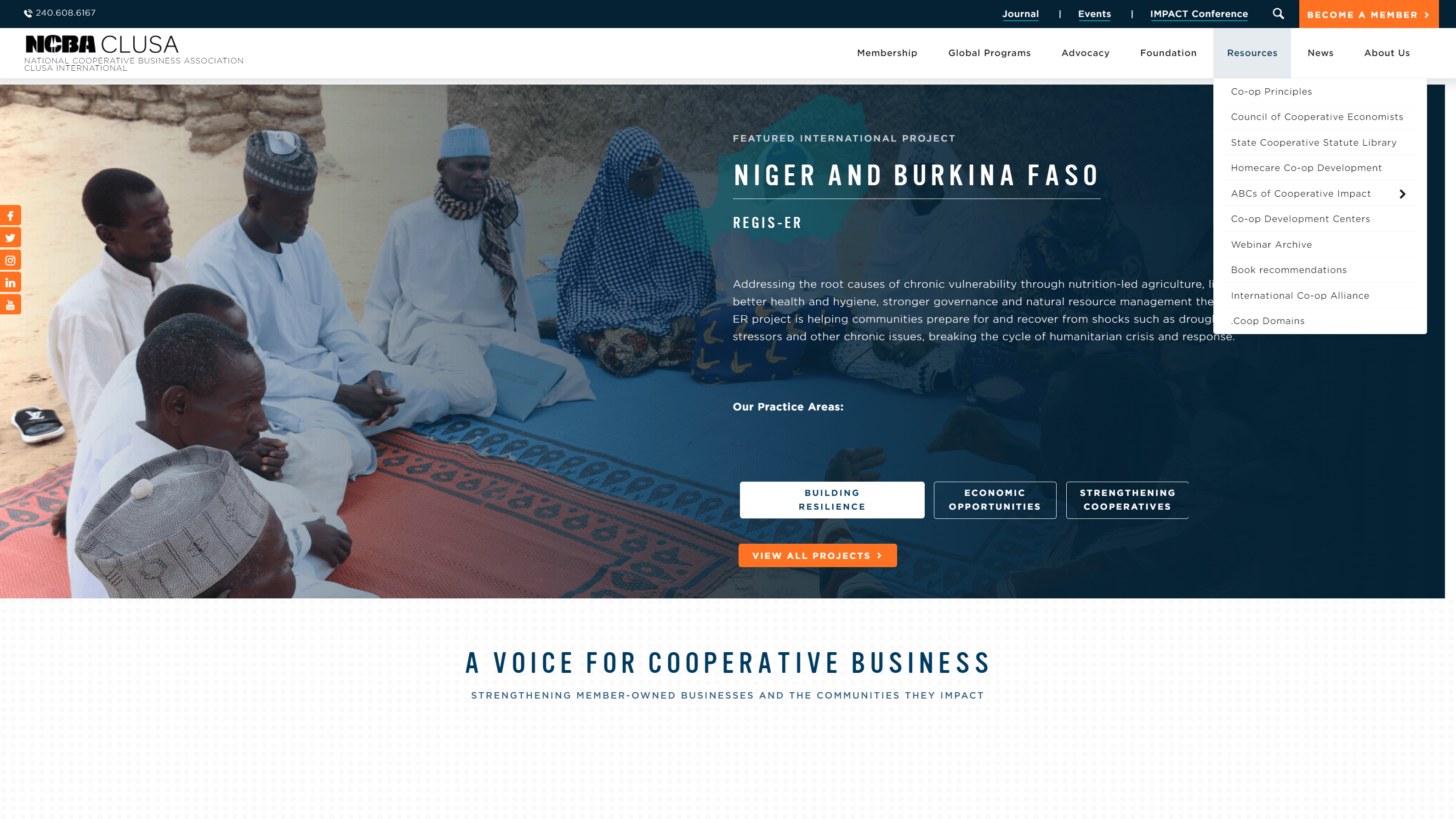 A group of individuals in traditional attire sitting on a mat in an outdoor setting, engaged in a discussion, representing a community project in Niger and Burkina Faso by NCBA CLUSA.