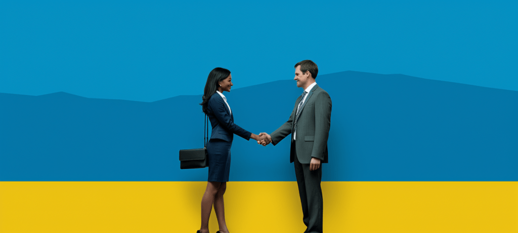 Woman in a business outfit shaking a man in a business suite's hand