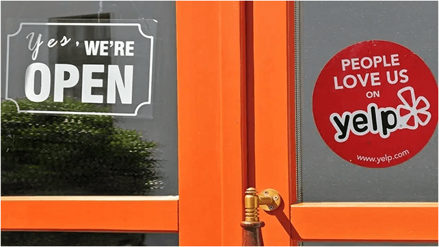 A glass window with a "People Love Us on Yelp” sticker