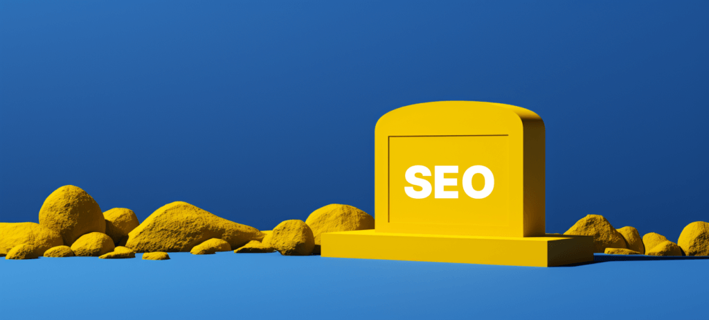 SEO written on a yellow tombstone surrounding by rocks