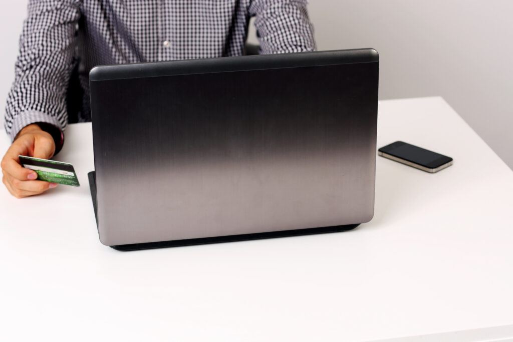 Businessman using credit card and laptop to shop online