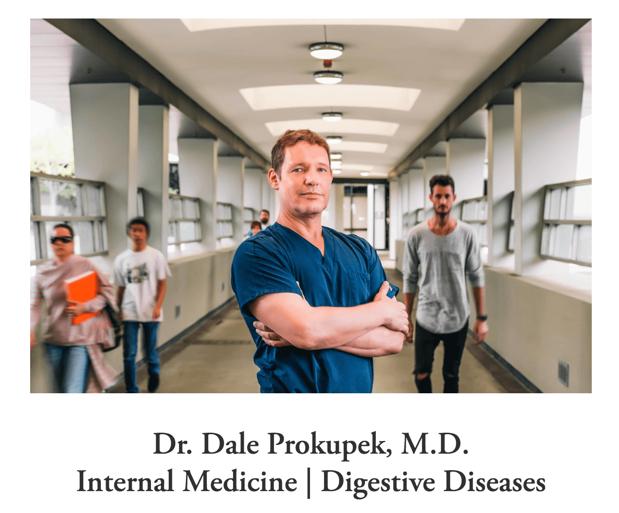 Photo of a doctor standing in a hallway