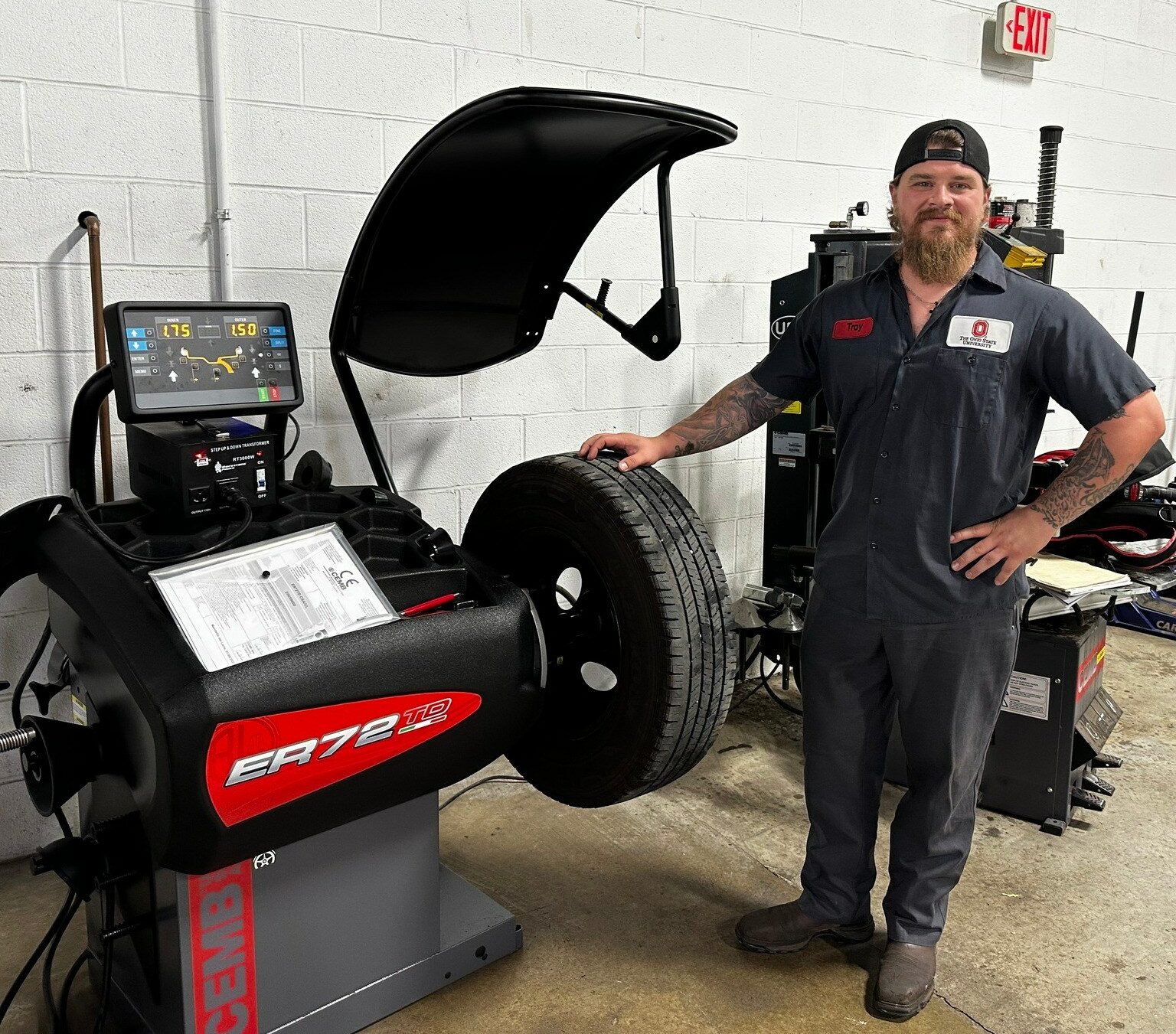 cemb usa employee standing next to wheel balancer