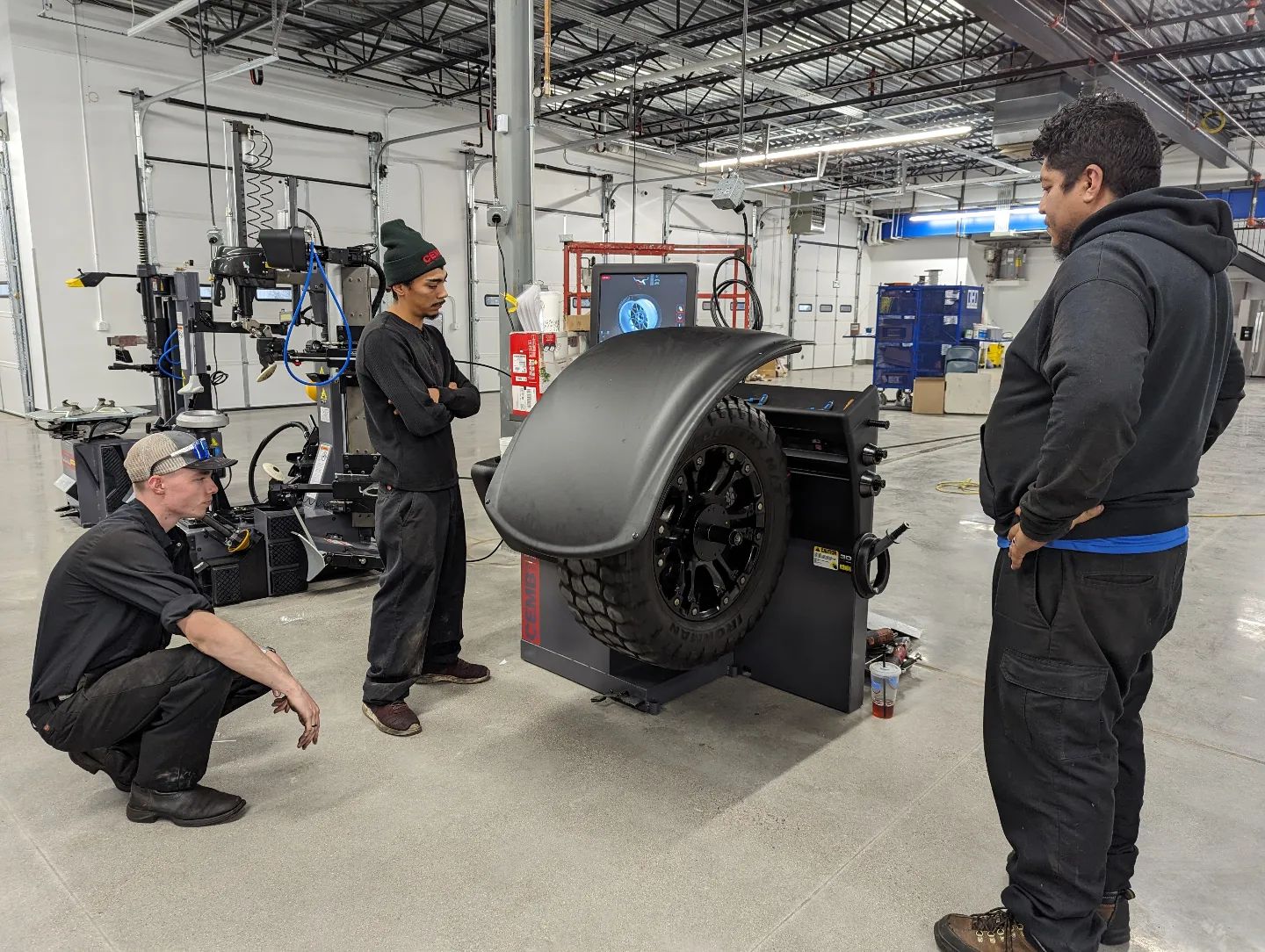 cemb employees learning how to use new equipment