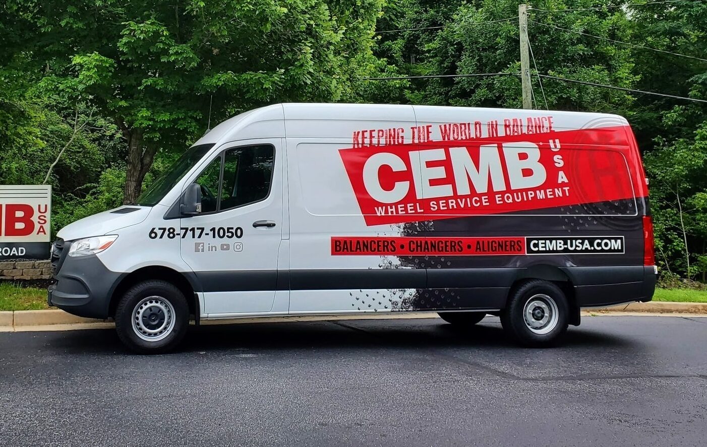 cemb usa van parked in front of cemb sign