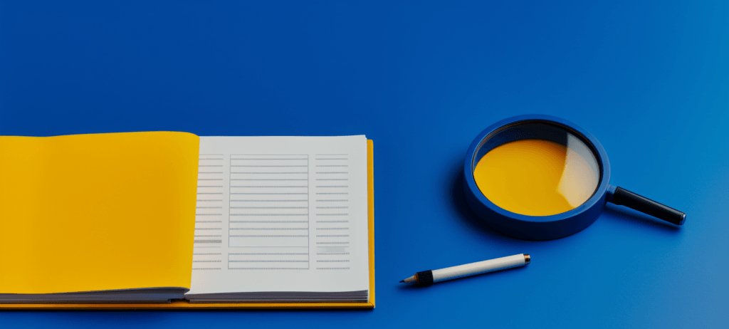 book and magnifying glass on table