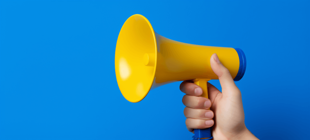 A hand holding a yellow megaphone against a blue background.