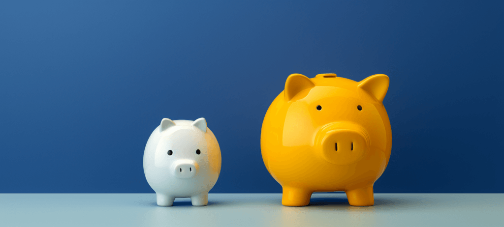 Two piggy banks, a small white one and a larger yellow one, on a surface against a blue background.