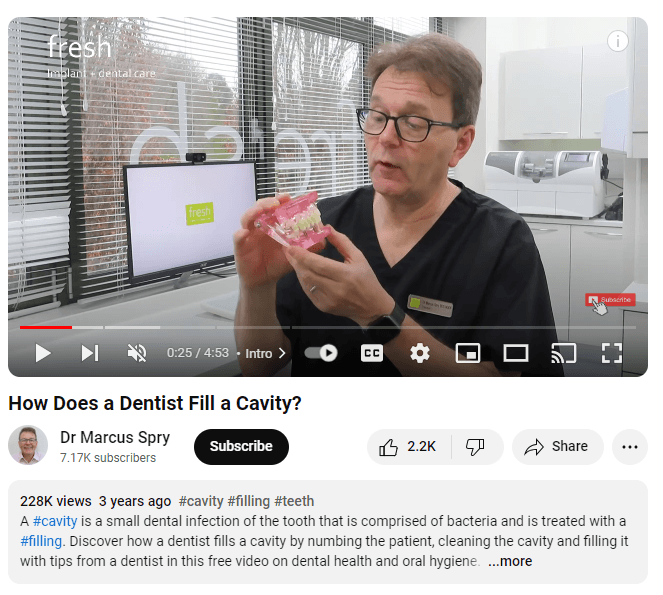 Dentist talking in a YouTube video about how cavities are filled