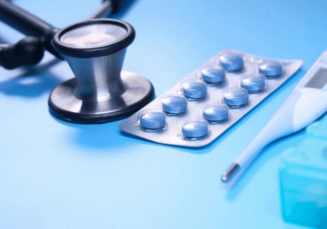 Medical tools and medicine on a blue backdrop