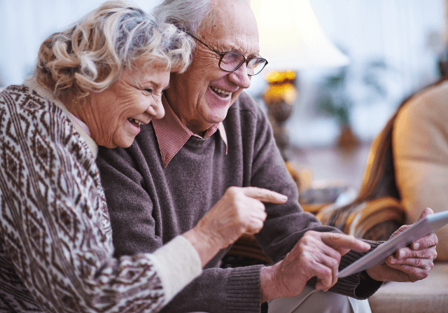 Senior couple at assisted living facility using tablet
