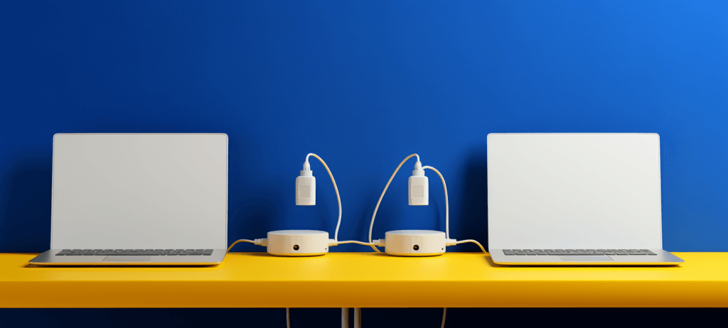 two computers with lamps next to them