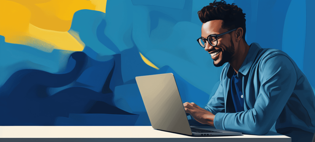 Black man with glasses smiling at a computer