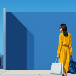 Woman in a yellow outfit standing with two bags