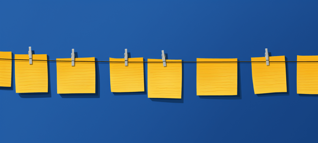 post it notes held on a clothes line with clothes pins