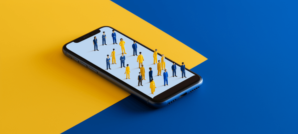 Cell phone with small people standing on top of it