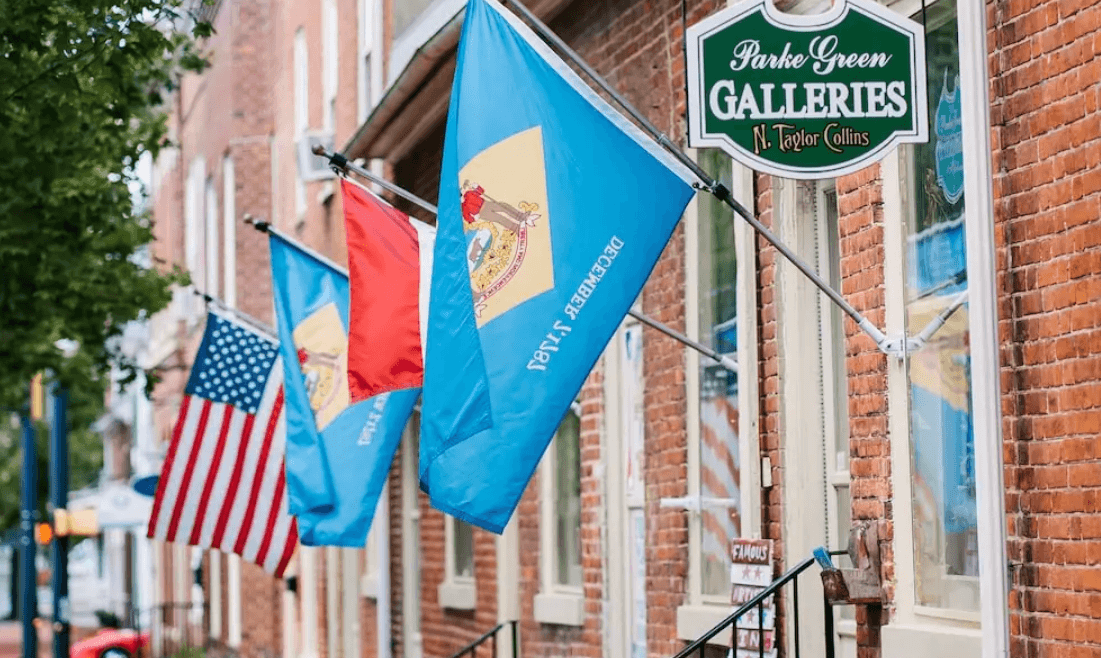 Flags hanging off a brick building