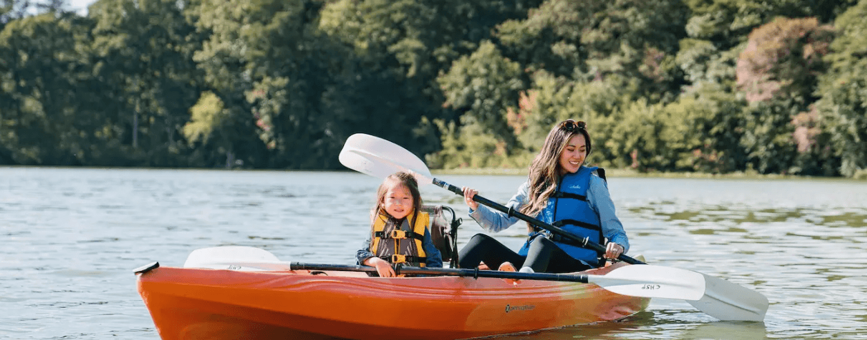 A mother and daughter kayaking on water