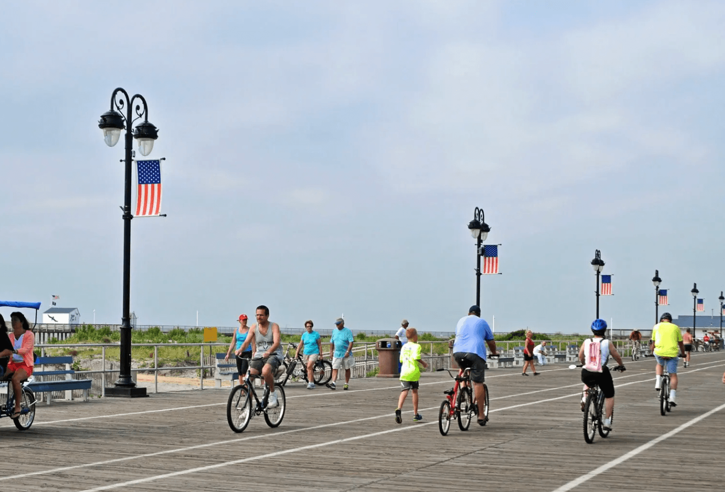 People riding bikes on the Ocean City, NJ boardwalk