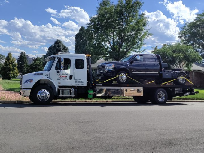 Tow truck with a pick up truck on the back