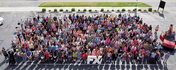 Company photo of everyone doing the wave