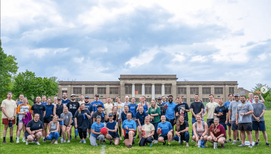 Group of people from the kickball tournament posing for a picture