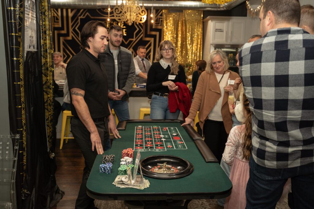 people standing around a game table