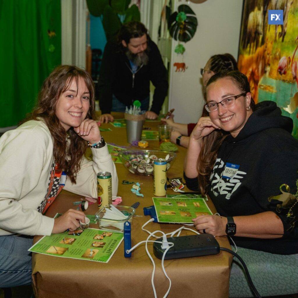 two girls posing for a picture with a jungle theme in the background