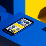 A smartphone with house photos on a blue and yellow geometric surface.