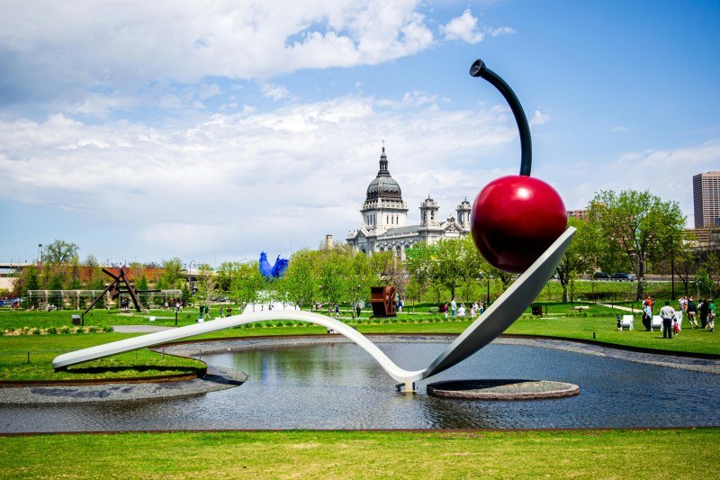 A sculpture of a cherry on a fountain in Minneapolis
