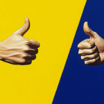 Two people in business suits giving a thumbs up