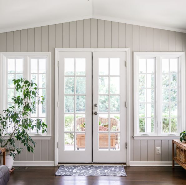 A living room with French doors and windows