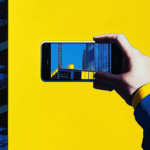 Hand holding smartphone displaying a construction site.