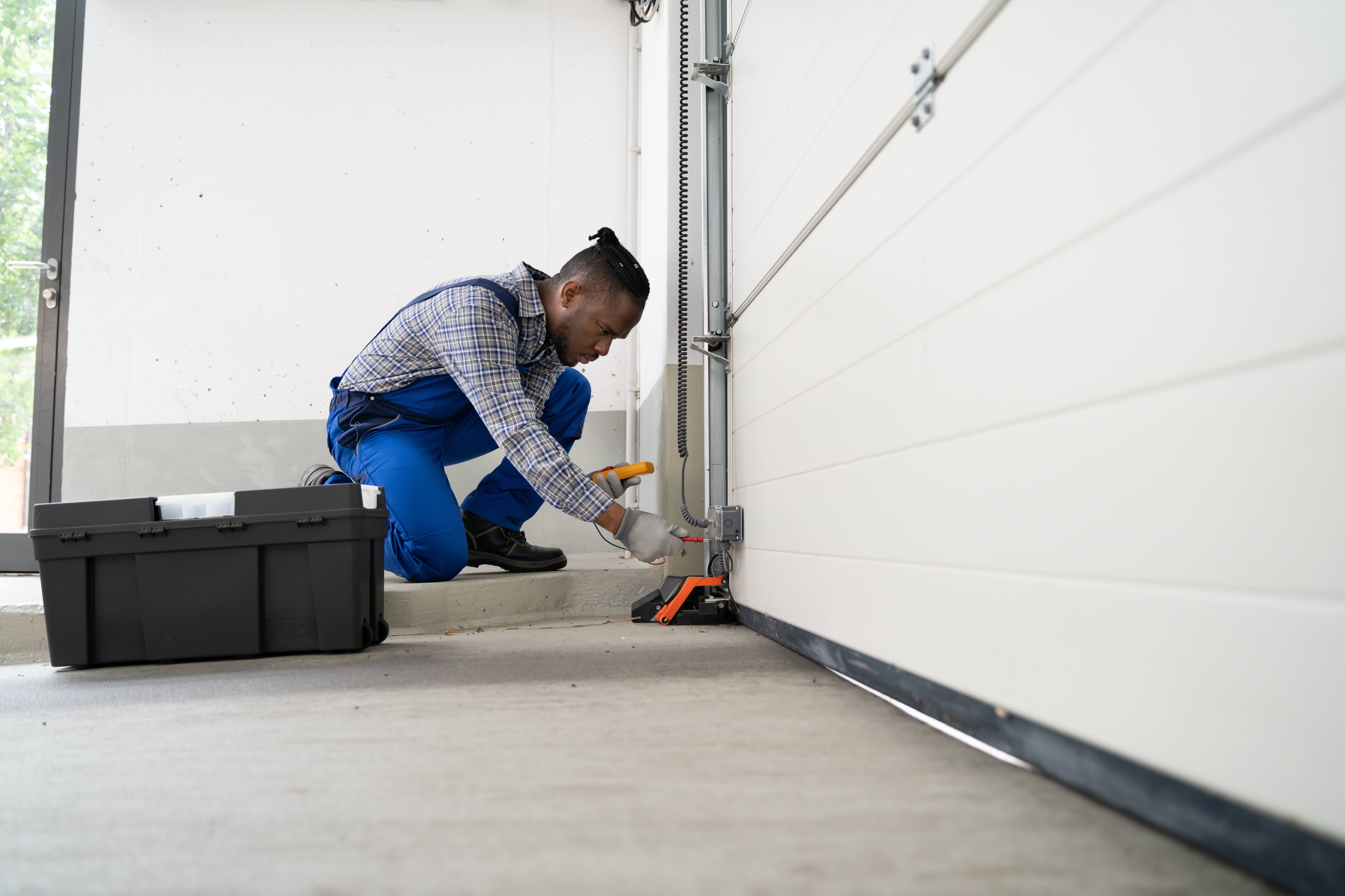 Garage Door Installation And Repair At Home. Contractor Man