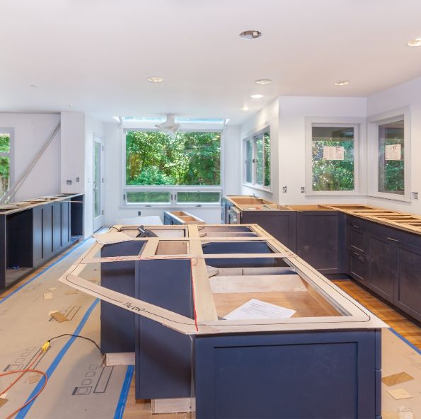 A partially finished kitchen with cabinets and countertops awaiting installation