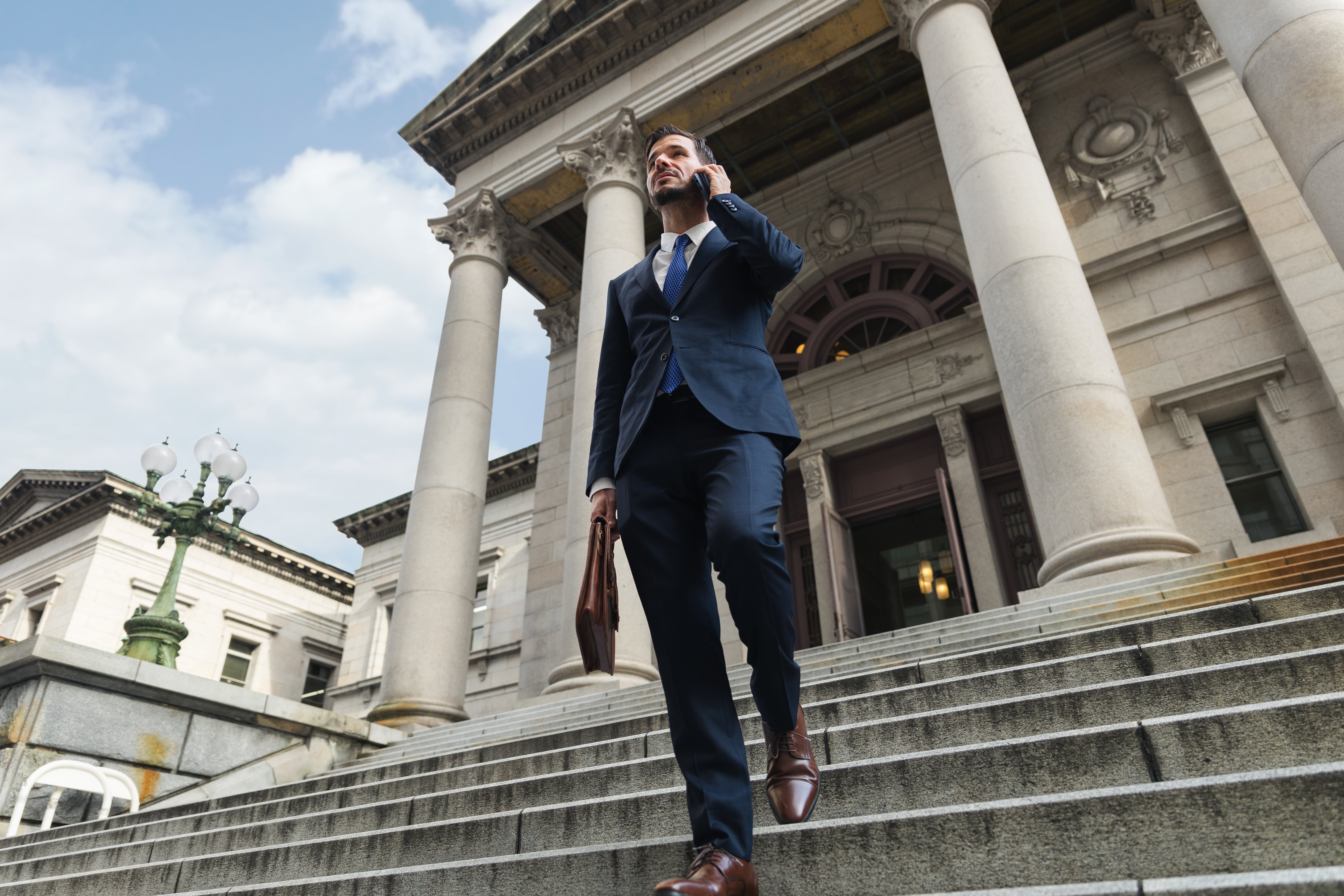 A financial advisor walking down stone steps